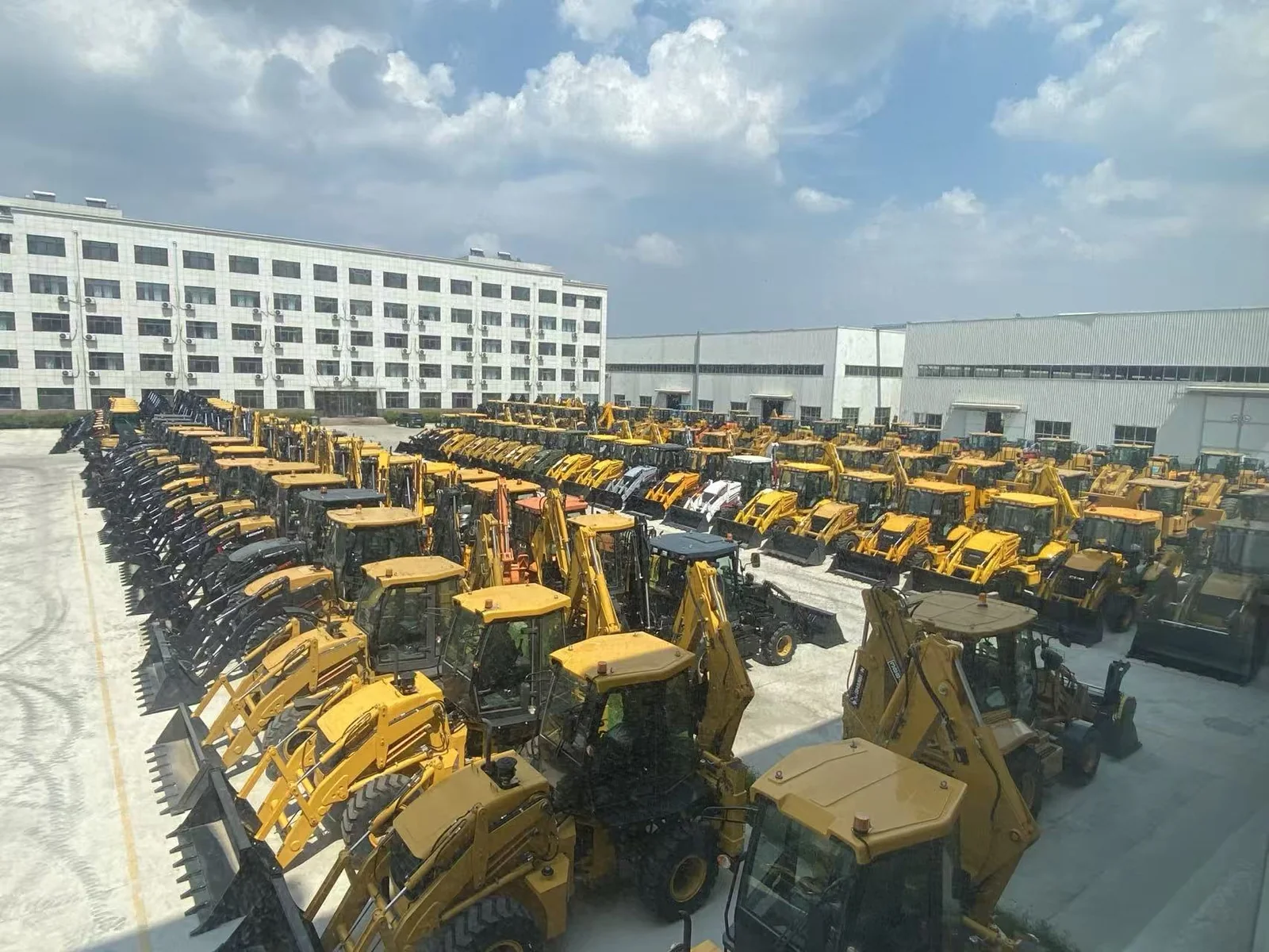 Backhoe loaders photographed in equipment yard