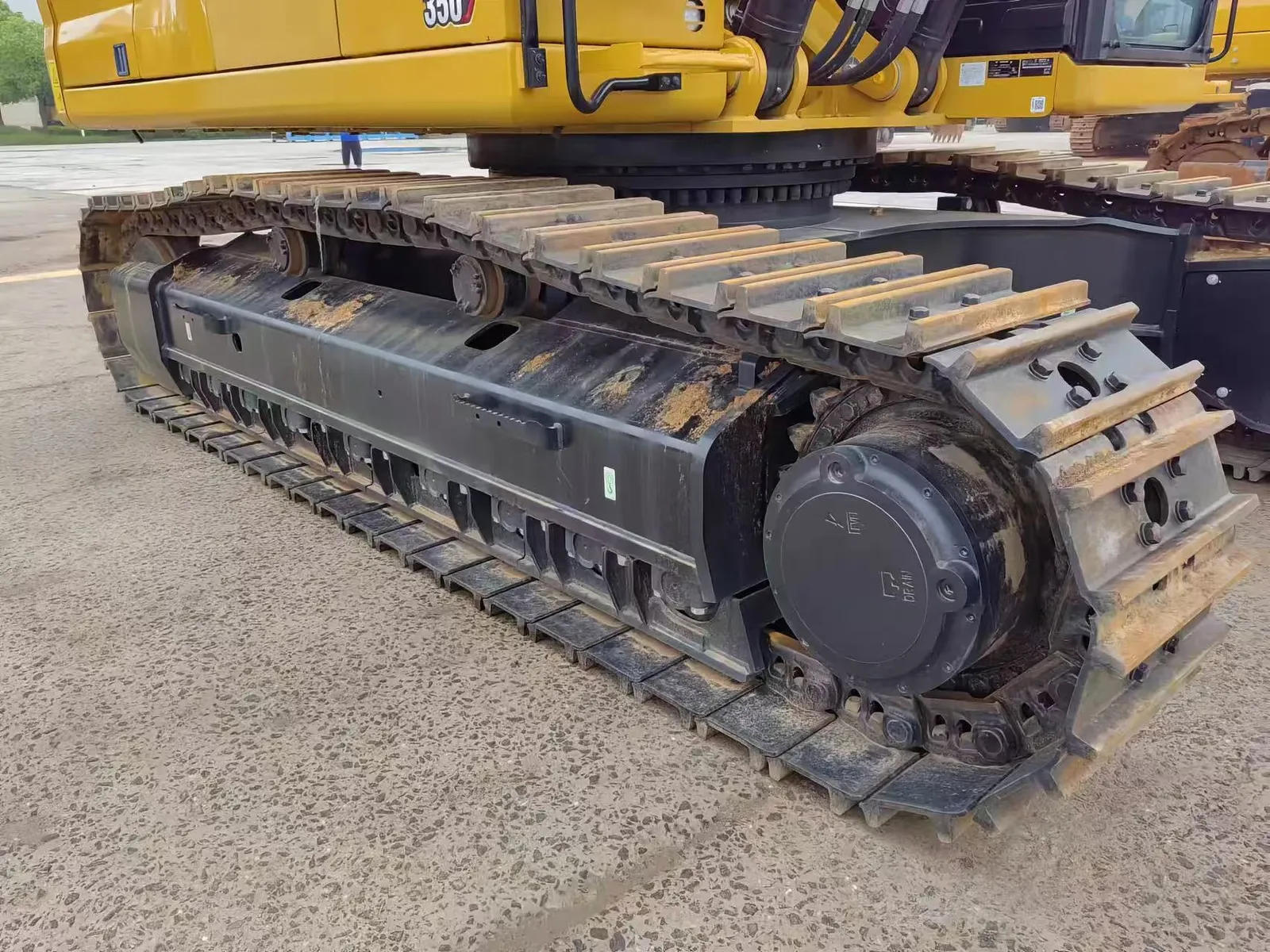 Undercarriage of a used CAT 350 excavator showing track, track shoes and drive sprocket, gallery photo