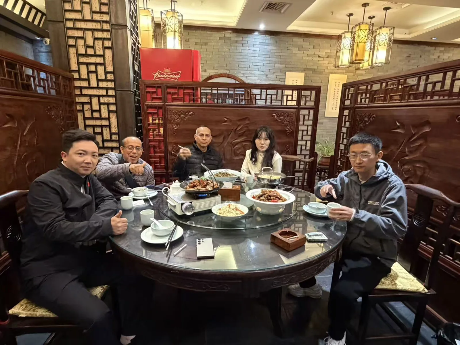 Several people seated around a table during an in-person meeting