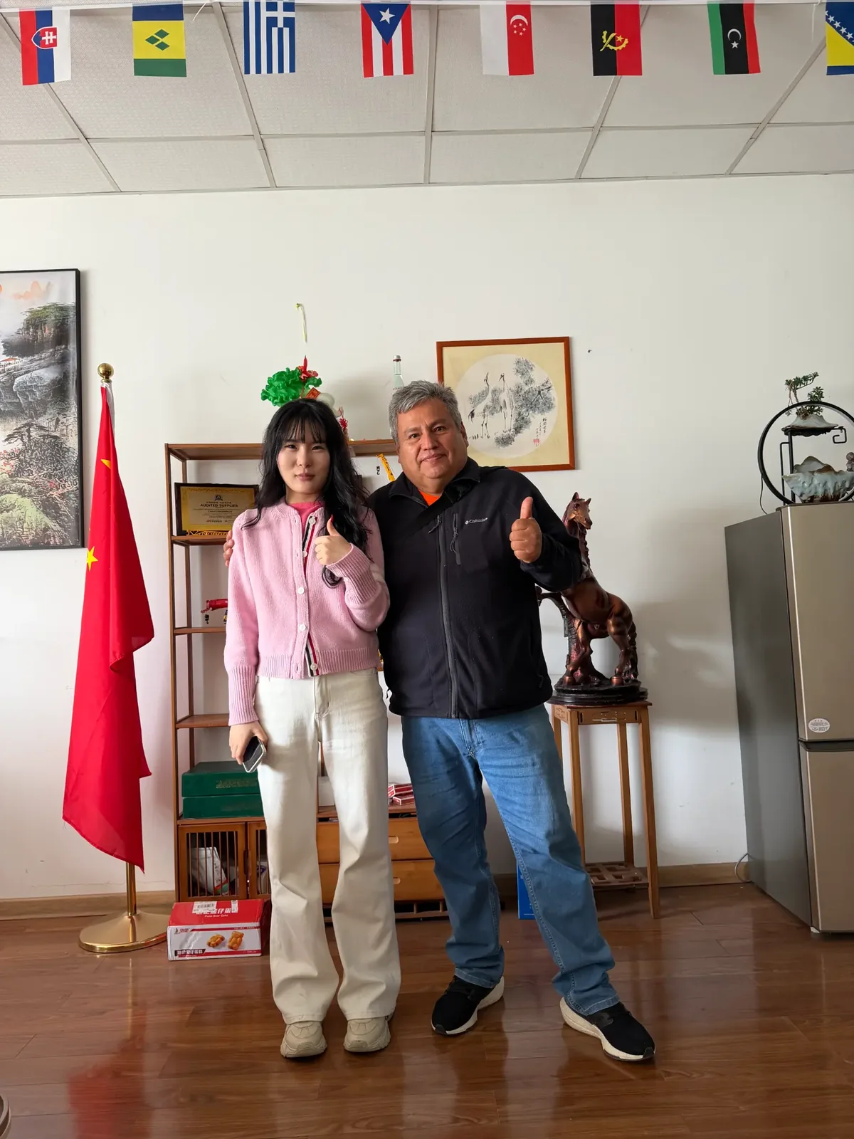 Two people shaking hands in front of the YUYAN-brand wall