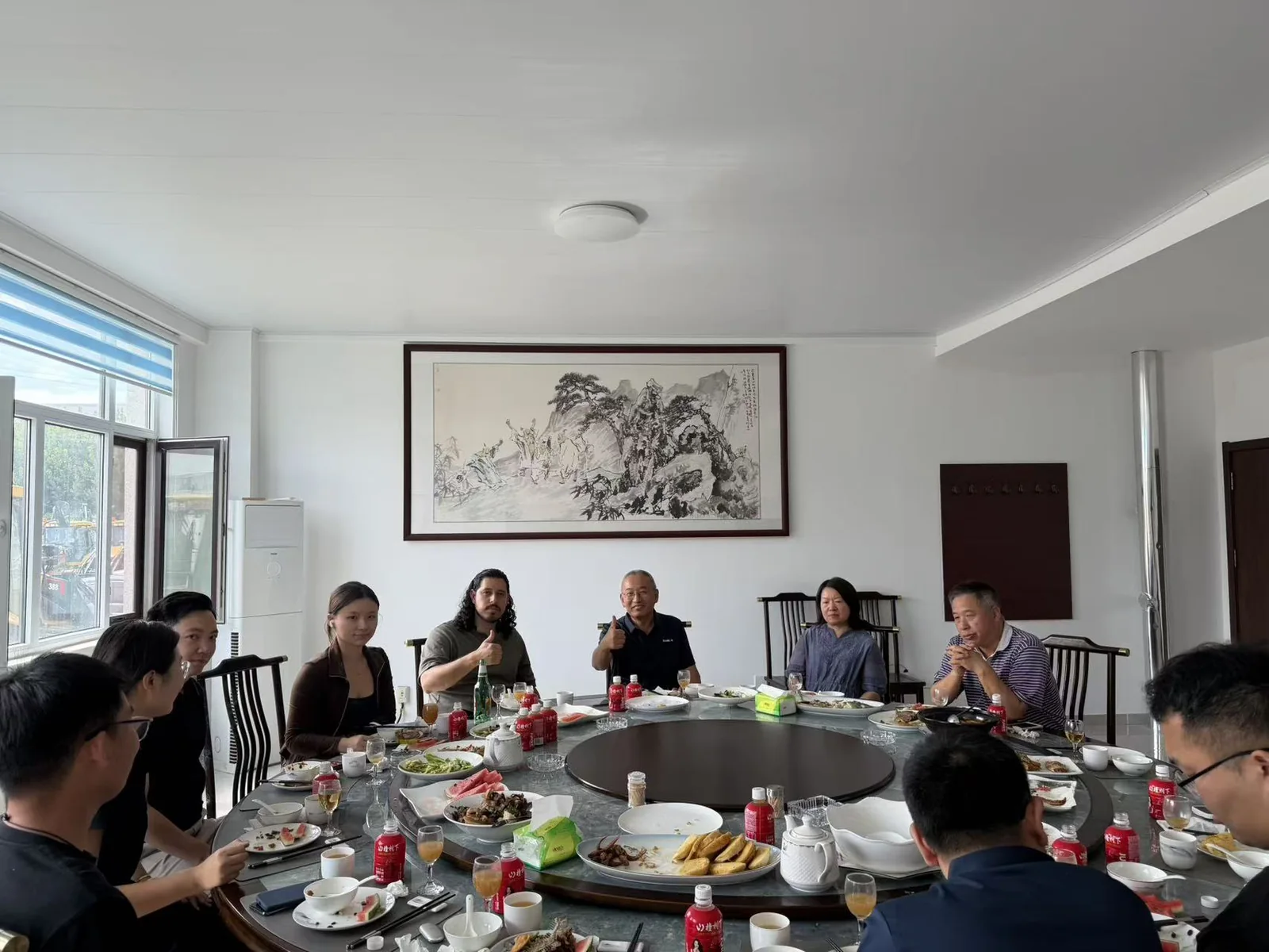 Several people seated around a table during an in-person meeting